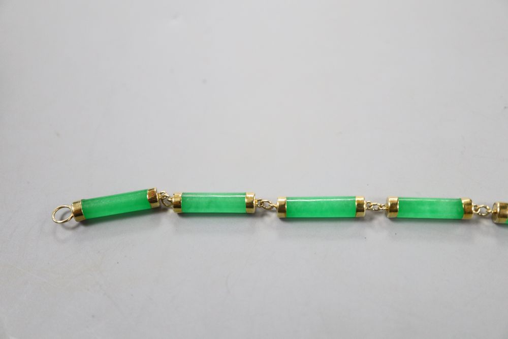A 585 yellow metal mounted jadeite bracelet, 19cm, gross 6.6 grams.